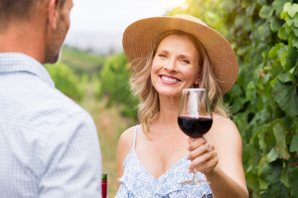 Middle aged woman enjoying a glass of wine at a vineyard in Willamette Valley wine country